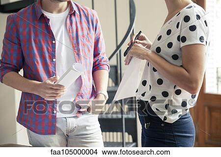 Picture - Colleagues chatting at work. Fotosearch