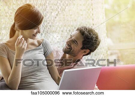 Couple making purchase online with credit card View Large Photo Image Stock Photograph - Couple making purchase online with credit card. Fotosearch