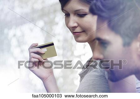 Stock Image - Couple making purchase with credit card. Fotosearch