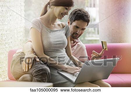 Stock Photography - Couple shopping online from home computer. Fotosearch