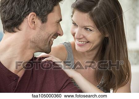 Stock Image - Couple smiling at each other affectionately. Fotosearch