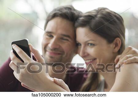 Couple taking selfie with smartphone View Large Photo Image Stock Image - Couple taking selfie with smartphone. Fotosearch