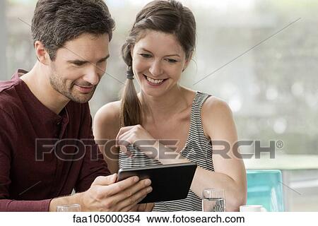 Digital tablets allow friends to easily share photos View Large Photo Image Picture - Digital tablets allow friends to easily share photos. Fotosearch