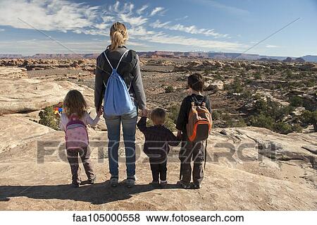 Family looking at scenic view in Canyonlands National Park, Utah, USA View Large Photo Image Stock Photo - Family looking at scenic view in Canyonlands National Park, Utah, USA. Fotosearch