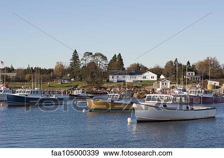 Fishing boats moored in marina near small fishing village in Maine, USA View Large Photo Image Stock Photo - Fishing boats moored in marina near small fishing village in Maine, USA. Fotosearch