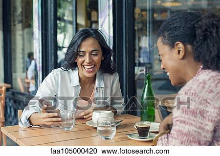 Friends meeting at sidewalk cafe View Large Photo Image Stock Image - Friends meeting at sidewalk cafe. Fotosearch