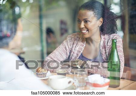 Friends meeting in coffee shop View Large Photo Image Stock Photography - Friends meeting in coffee shop. Fotosearch