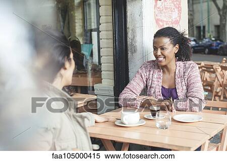 Friends talking at sidewalk cafe View Large Photo Image Stock Photography - Friends talking at sidewalk cafe. Fotosearch