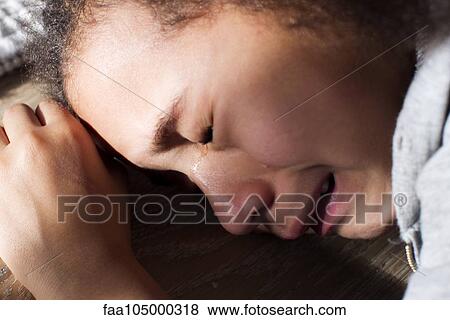 Stock Photo - Girl crying, close-up. Fotosearch