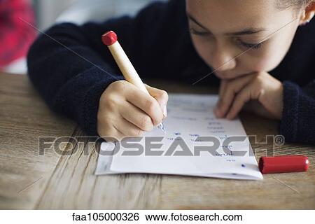 Girl doing homework, close-up View Large Photo Image Stock Photograph - Girl doing homework, close-up. Fotosearch