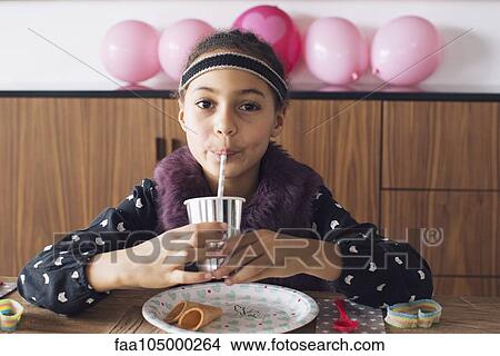 Girl drinking through a straw View Large Photo Image Picture - Girl drinking through a straw. Fotosearch