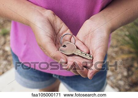 Girl holding key in cupped hands, cropped View Large Photo Image Stock Image - Girl holding key in cupped hands, cropped. Fotosearch