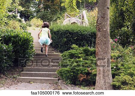 Girl in tutu running up stairs in park, rear view View Large Photo Image Stock Photograph - Girl in tutu running up stairs in park, rear view. Fotosearch