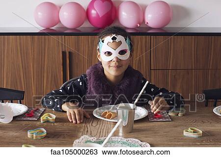 Girl wearing festive mask at birthday party View Large Photo Image Stock Image - Girl wearing festive mask at birthday party. Fotosearch