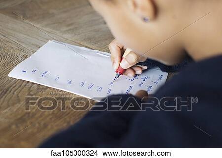 Girl writing in cursive on paper, cropped View Large Photo Image Picture - Girl writing in cursive on paper, cropped. Fotosearch