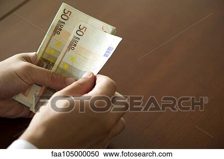 Hands counting fifty euro banknotes View Large Photo Image Stock Image - Hands counting fifty euro banknotes. Fotosearch