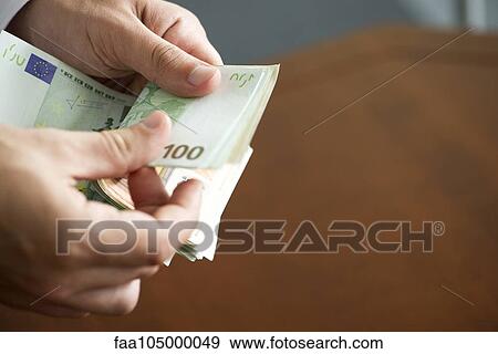 Hands counting stack of cash, cropped View Large Photo Image Stock Photo - Hands counting stack of cash, cropped. Fotosearch