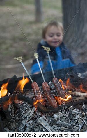 Hotdogs cooking on grill at campground View Large Photo Image Stock Image - Hotdogs cooking on grill at campground. Fotosearch