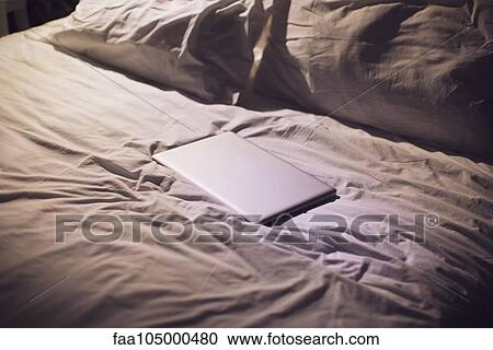 Laptop computer on bed View Large Photo Image Stock Image - Laptop computer on bed. Fotosearch