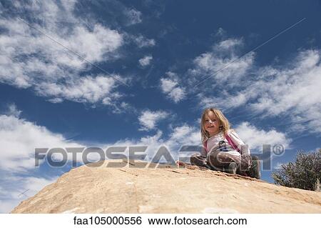 Little girl sitting on top of rock, portrait View Large Photo Image Stock Photograph - Little girl sitting on top of rock, portrait. Fotosearch