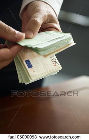 Man counting stack of cash, cropped View Large Photo Image Stock Image - Man counting stack of cash, cropped. Fotosearch