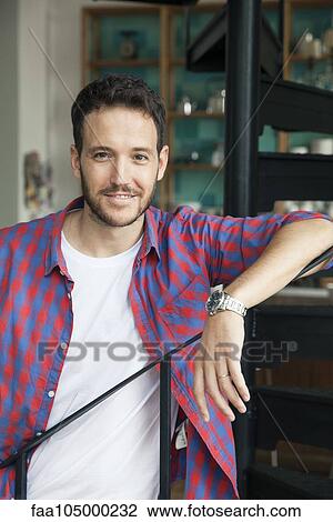 Man leaning against bannister, portrait View Large Photo Image Stock Image - Man leaning against bannister, portrait. Fotosearch