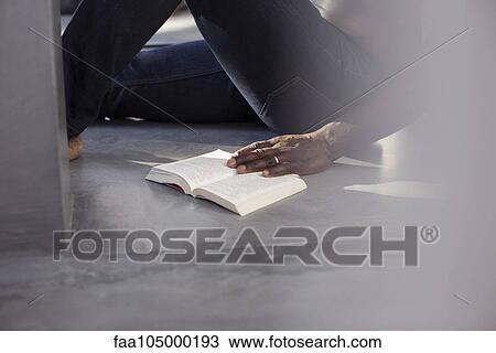Man reading book on floor, cropped View Large Photo Image Stock Image - Man reading book on floor, cropped. Fotosearch