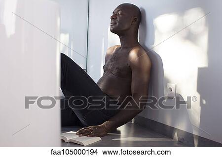 Man relaxing on floor with book, eyes closed View Large Photo Image Picture - Man relaxing on floor with book, eyes closed. Fotosearch
