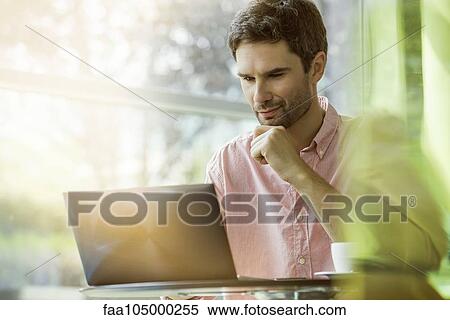 Man using laptop computer View Large Photo Image Stock Photography - Man using laptop computer. Fotosearch