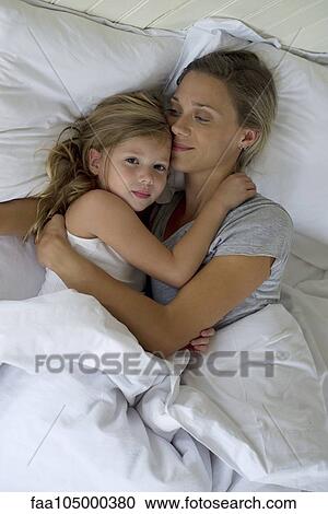 Mother and daughter in bed embracing View Large Photo Image Stock Image - Mother and daughter in bed embracing. Fotosearch