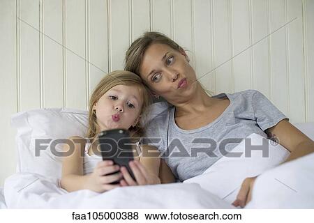 Mother and daughter posing for selfie View Large Photo Image Stock Photo - Mother and daughter posing for selfie. Fotosearch