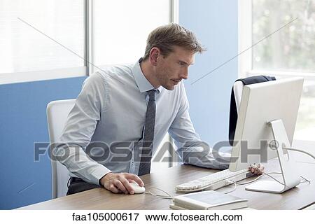 Office worker focused on work View Large Photo Image Stock Photo - Office worker focused on work. Fotosearch