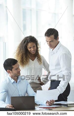 Office worker showing document to colleagues View Large Photo Image Stock Photo - Office worker showing document to colleagues. Fotosearch