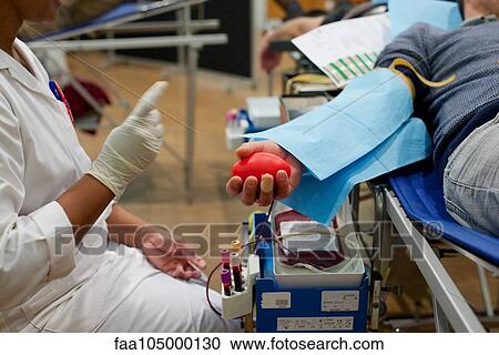 Stock Image - Person donating blood, cropped. Fotosearch