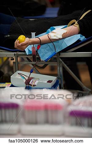 Stock Photograph - Person donating blood, cropped. Fotosearch