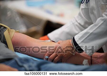 Stock Image - Person giving blood, close-up. Fotosearch