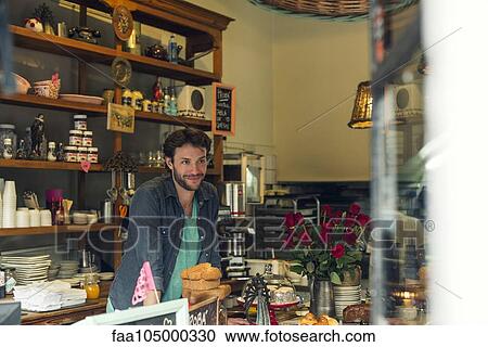 Shopkeeper behind counter at coffee shop View Large Photo Image Stock Image - Shopkeeper behind counter at coffee shop. Fotosearch