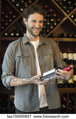 Shopper selecting bottle of wine View Large Photo Image Stock Photo - Shopper selecting bottle of wine. Fotosearch