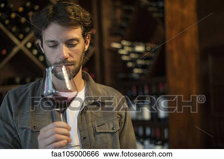 Sommelier evaluating quality of glass of wine View Large Photo Image Stock Photograph - Sommelier evaluating quality of glass of wine. Fotosearch