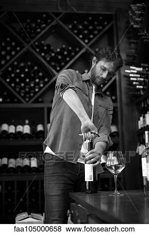 Sommelier opening bottle of wine View Large Photo Image Stock Photo - Sommelier opening bottle of wine. Fotosearch