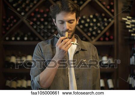 Sommelier smelling wine cork View Large Photo Image Stock Image - Sommelier smelling wine cork. Fotosearch