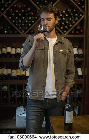 Picture - Sommelier sniffing glass of wine. Fotosearch