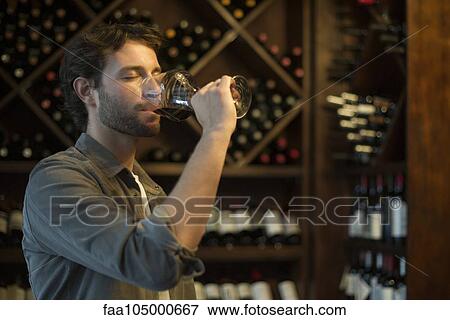 Stock Photo - Sommelier tasting glass of wine. Fotosearch