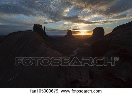 Sunset behind buttes in Monument Valley, Utah, USA View Large Photo Image Stock Photo - Sunset behind buttes in Monument Valley, Utah, USA. Fotosearch