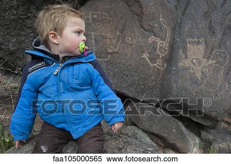 Toddler boy studying petroglyph in Yellowstone National Park, USA View Large Photo Image Stock Photography - Toddler boy studying petroglyph in Yellowstone National Park, USA. Fotosearch