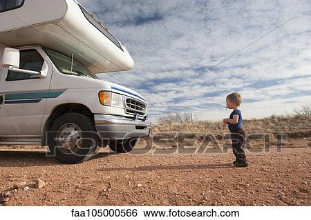 Toddler standing in front of motor home View Large Photo Image Stock Photograph - Toddler standing in front of motor home. Fotosearch