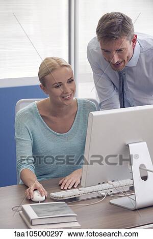 Training new office worker View Large Photo Image Stock Photo - Training new office worker. Fotosearch