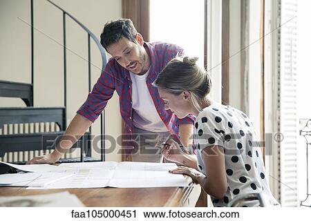 Wife and husband reviewing blueprints for home renovation View Large Photo Image Stock Image - Wife and husband reviewing blueprints for home renovation. Fotosearch