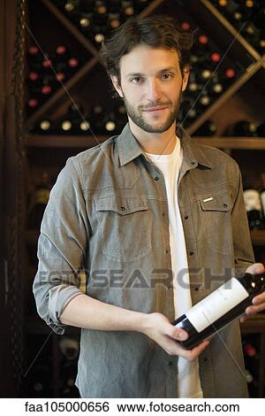 Wine salesman selecting bottle of wine View Large Photo Image Stock Photograph - Wine salesman selecting bottle of wine. Fotosearch