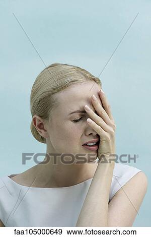 Woman covering face with hand and grimacing View Large Photo Image Stock Photo - Woman covering face with hand and grimacing. Fotosearch